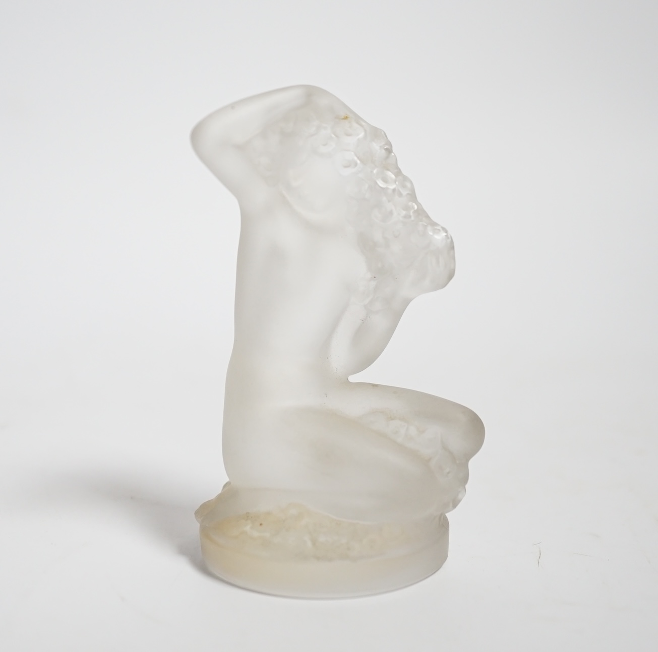 A Lalique glass figure of a kneeling female, signed, 8cm high